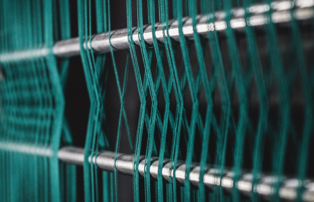 green threads wrapping around poles