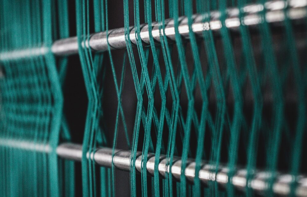 green threads wrapping around poles