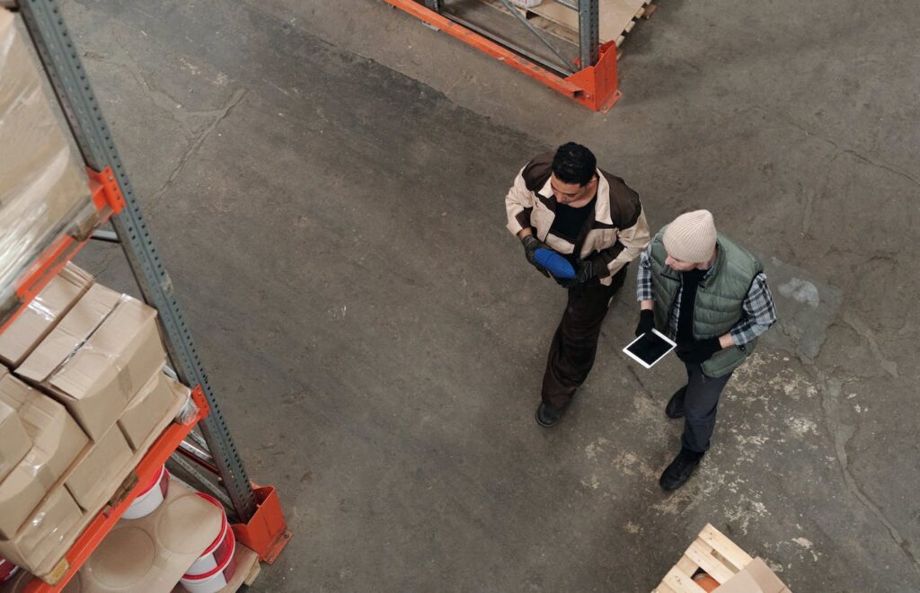 Workers walking through a warehouse with a tablet