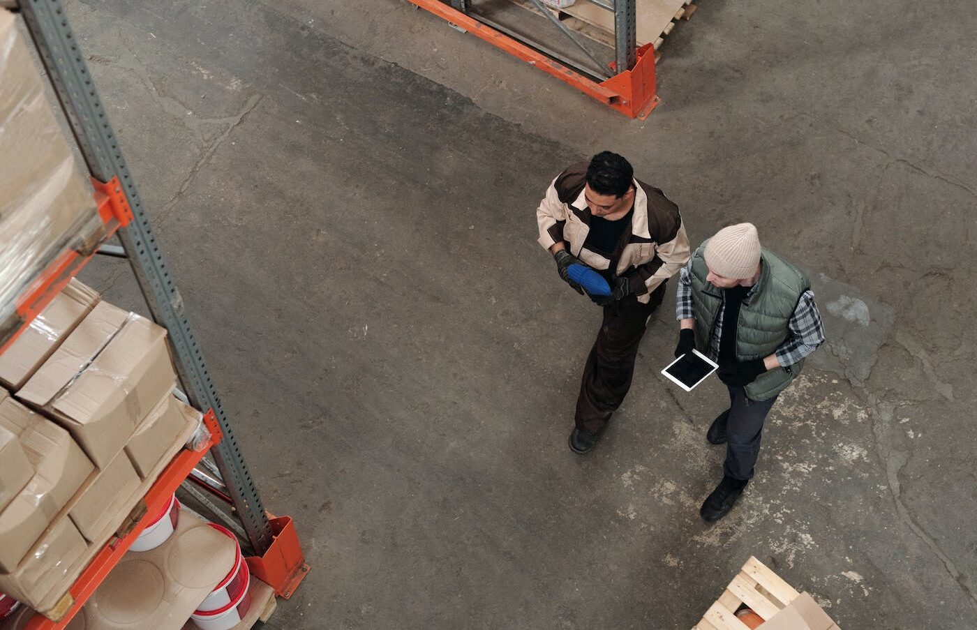 Workers walking through a warehouse with a tablet